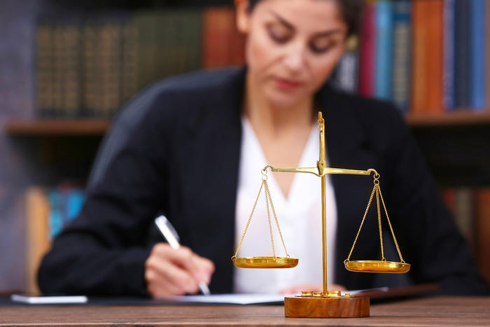 blog full female lawyer and scales of justice