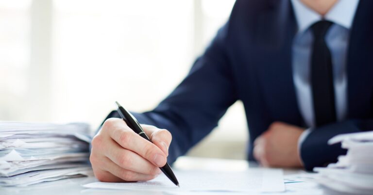 close up businessman holding pen scaled 1